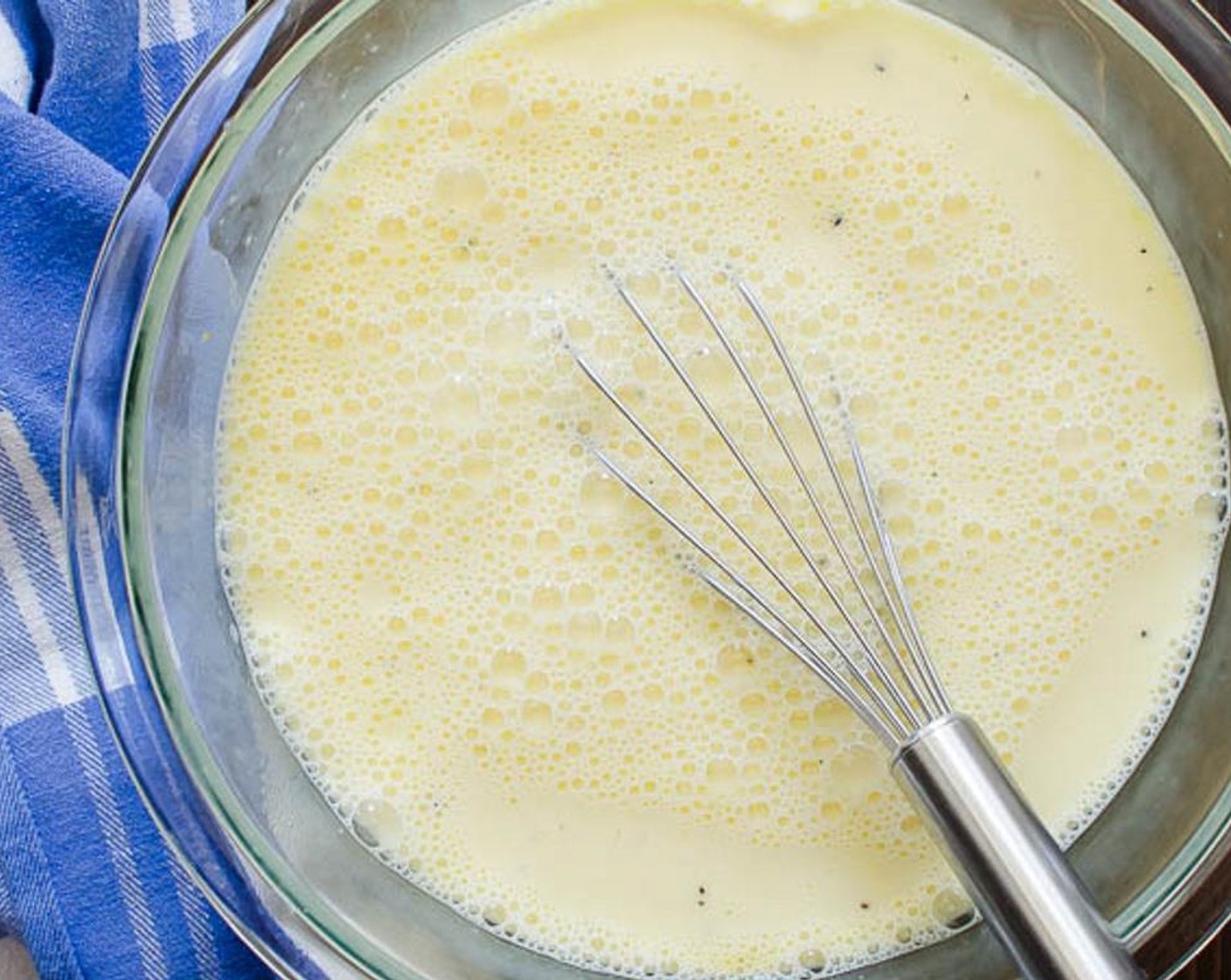 step 4 In a large bowl, combine the Eggland's Best Classic Eggs (8), Kosher Salt (1/2 tsp), and Freshly Ground Black Pepper (1/2 tsp). Whisk the eggs, then add the Milk (3 cups) and whisk to combine.
