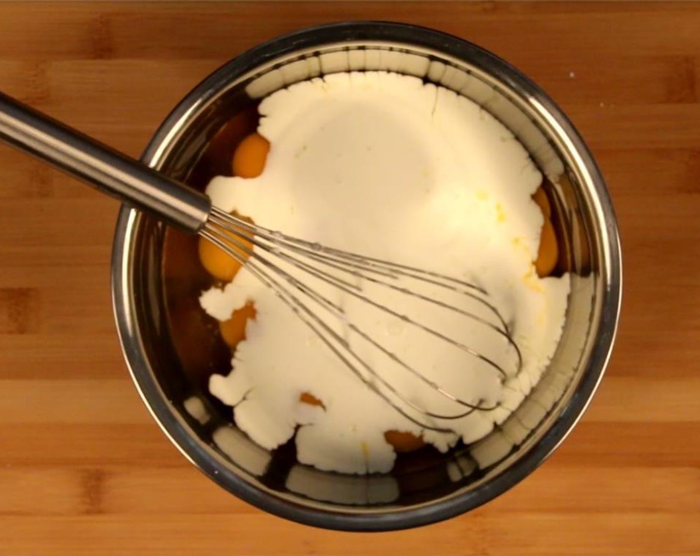 step 6 In a large bowl, add the Eggland's Best Classic Eggs (12), Heavy Cream (1/2 cup), and three-quarters of the Emmental Cheese (1 cup) and whisk together. Season with Salt (to taste) and Ground Black Pepper (to taste).