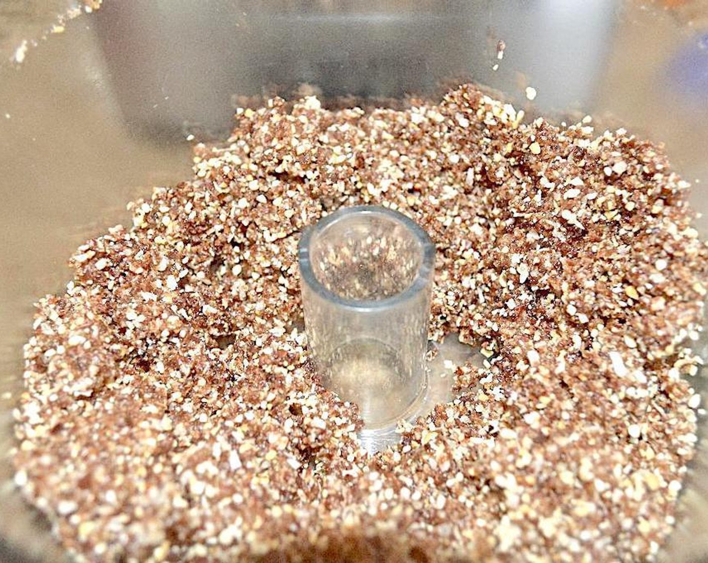 step 1 Add Sun-Maid Raisins (2 cups), Coconut Flakes (3/4 cup), Cashew Nuts (2/3 cup), Ground Flaxseed (2 Tbsp), and Simply Organic Cinnamon, Ground (1/2 tsp) into food processor. Pulse it all together until it is fine but still has some texture.