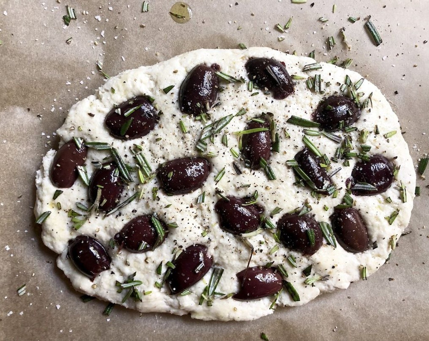 step 11 For the focaccia with olives and rosemary: Strew the Kalamata Olives (2 1/2 cups) over the surface of the dough. Allow some of the dough surface to show through the olives. Sprinkle with Fresh Rosemary (1/2 tsp). Season with Coarse Salt (to taste) and Freshly Ground Black Pepper (to taste). Finish with a light drizzle of Extra-Virgin Olive Oil (1 tsp).