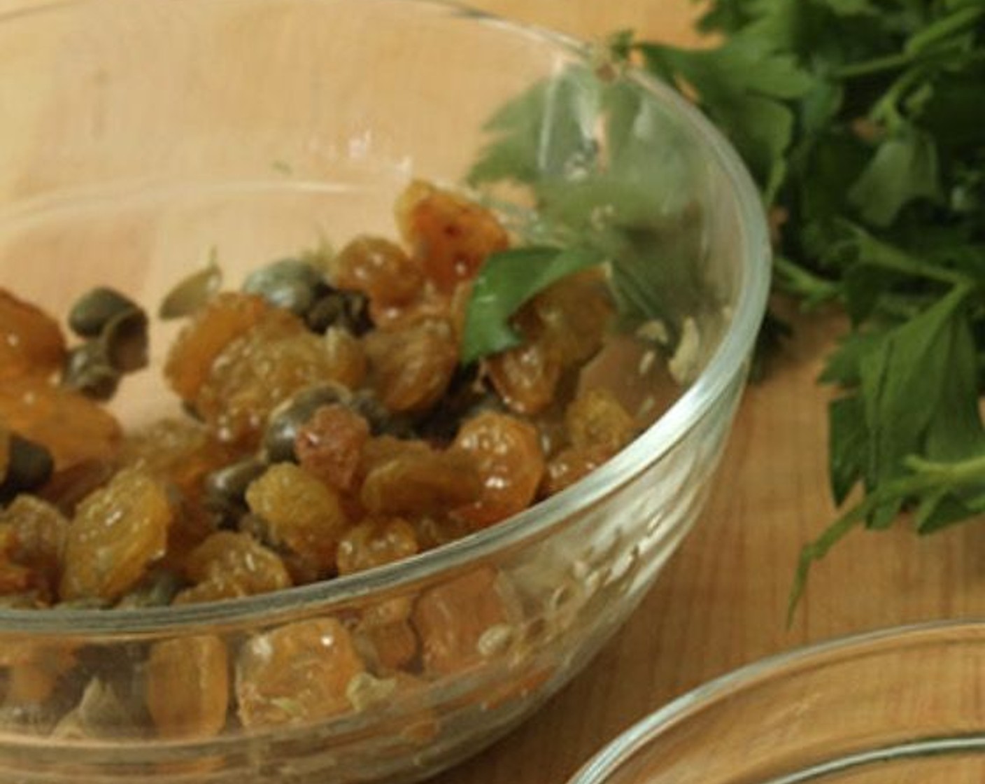 step 5 Meanwhile, in a small bowl, combine the Capers (2 Tbsp), Sun-Maid Raisins (4 Tbsp), and Champagne Vinegar (1 Tbsp) and set aside.