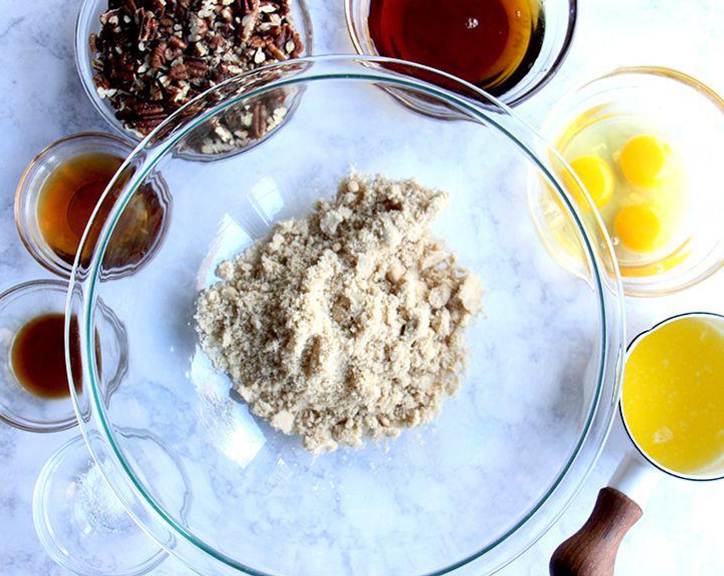 step 6 To make the filling, in a large bowl, whisk together the Dark Brown Sugar (1 cup), Maple Syrup (1/2 cup), Farmhouse Eggs® Large Brown Eggs (3), Butter (4 Tbsp), Bourbon (3 Tbsp), Vanilla Extract (1 tsp), and Salt (1/4 tsp). Stir in the Roasted Pecans (2 cups).